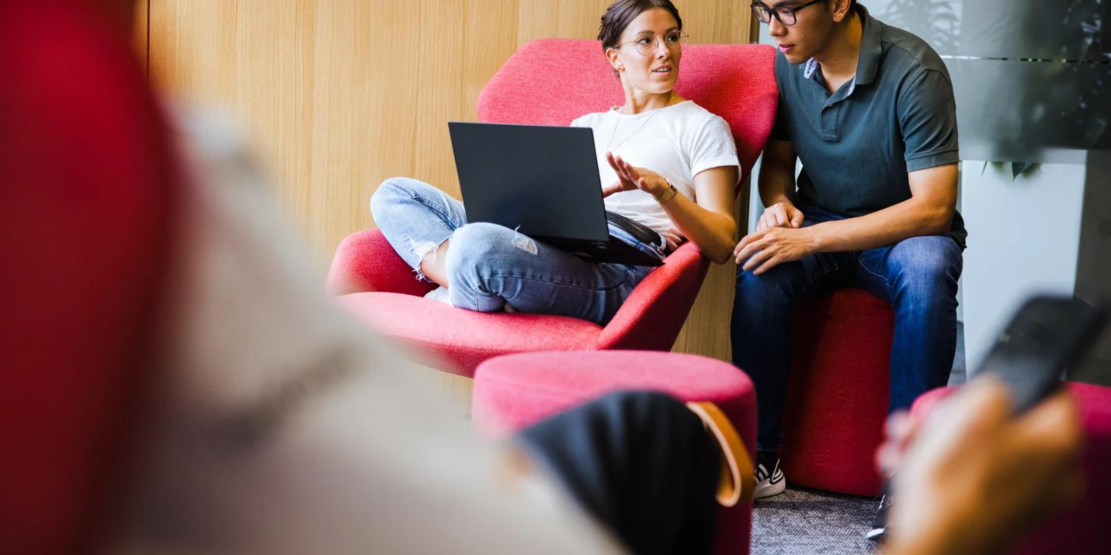 Cloud and IT services enabling scalable and efficient system operations Two professionals collaborating on a laptop in a modern IT work environment