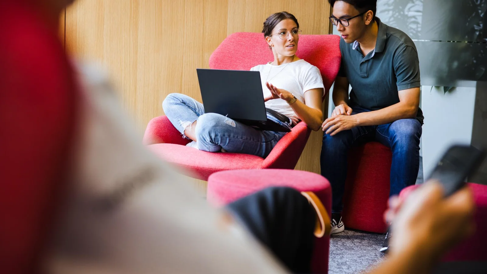 Cloud and IT services enabling scalable and efficient system operations Two professionals collaborating on a laptop in a modern IT work environment