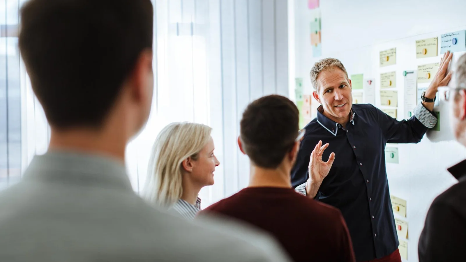 Build On Us. So You Can Build What Matters A Vector Trainer explaining concepts to a group during a technical workshop session about software defined systems and software ecosystems