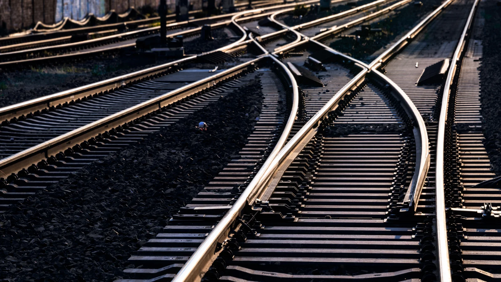 Vector supports evolving rail systems with development and validation workflows that improve long-term operational reliability. Image of multiple railway tracks lit by a gloomy sunset.